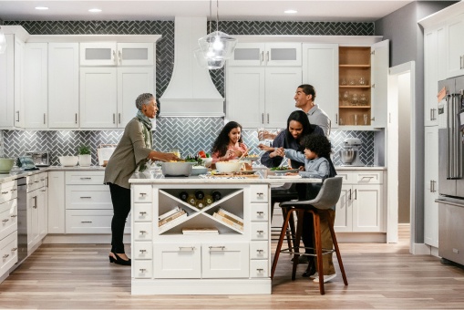 A happy family in a white and grey kitchen.